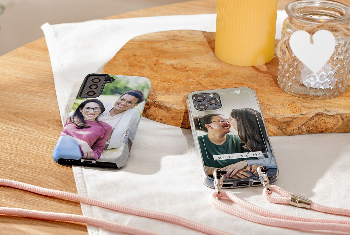 Due smartphone con cover personalizzate con foto, su un tavolo.